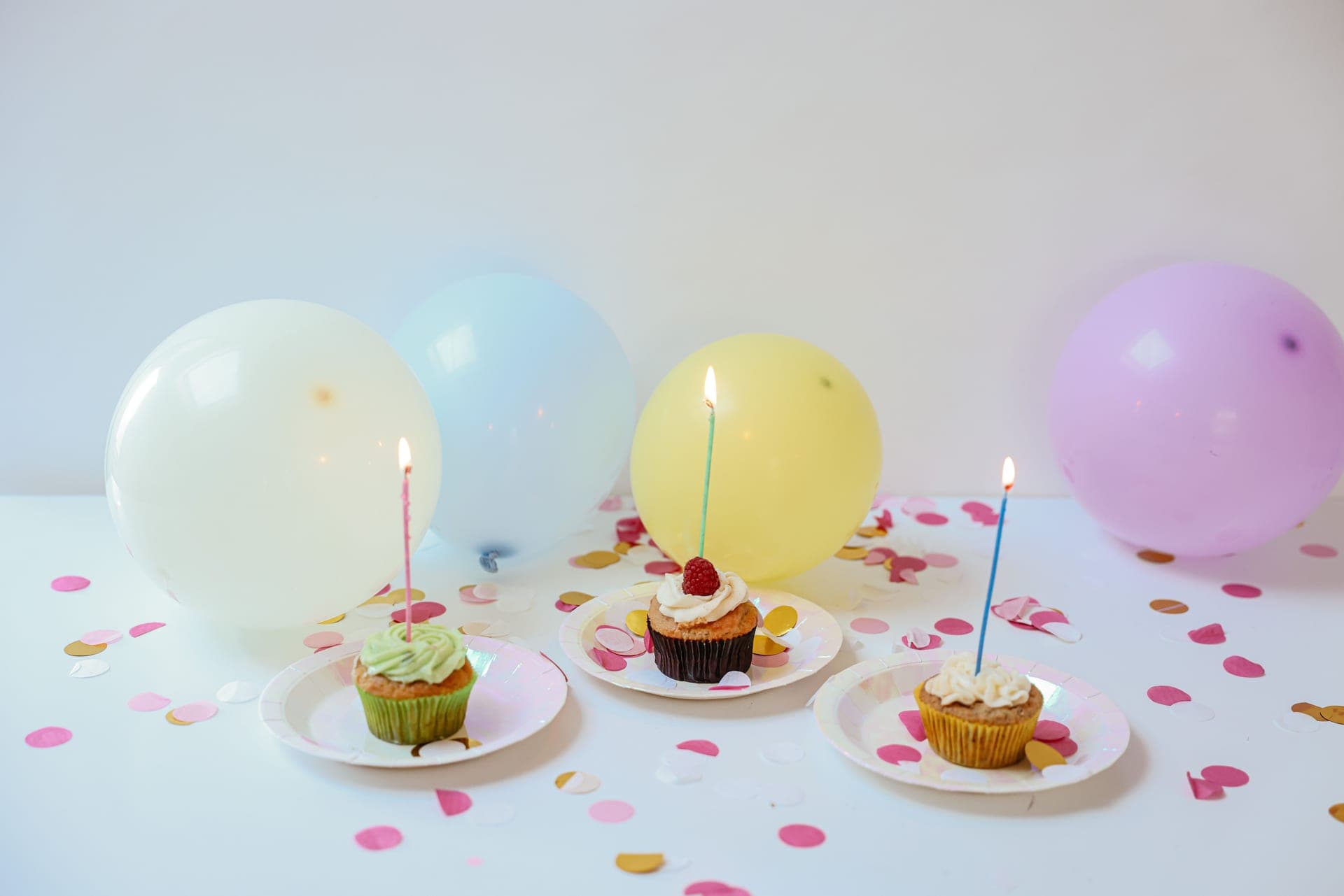 A cheerful birthday scene with candles and pastel balloons