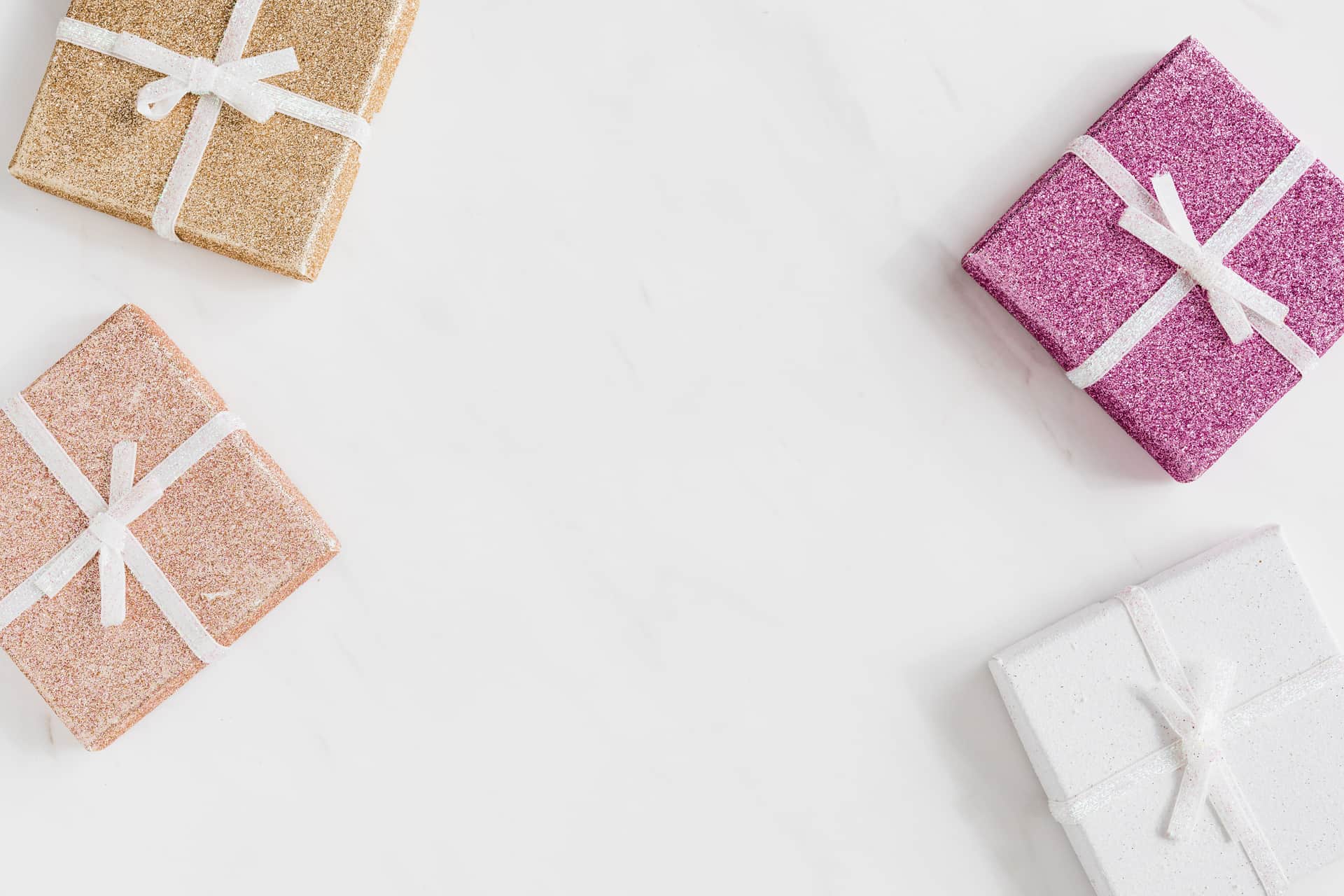 Wrapped gift boxes with ribbon on a soft pastel background